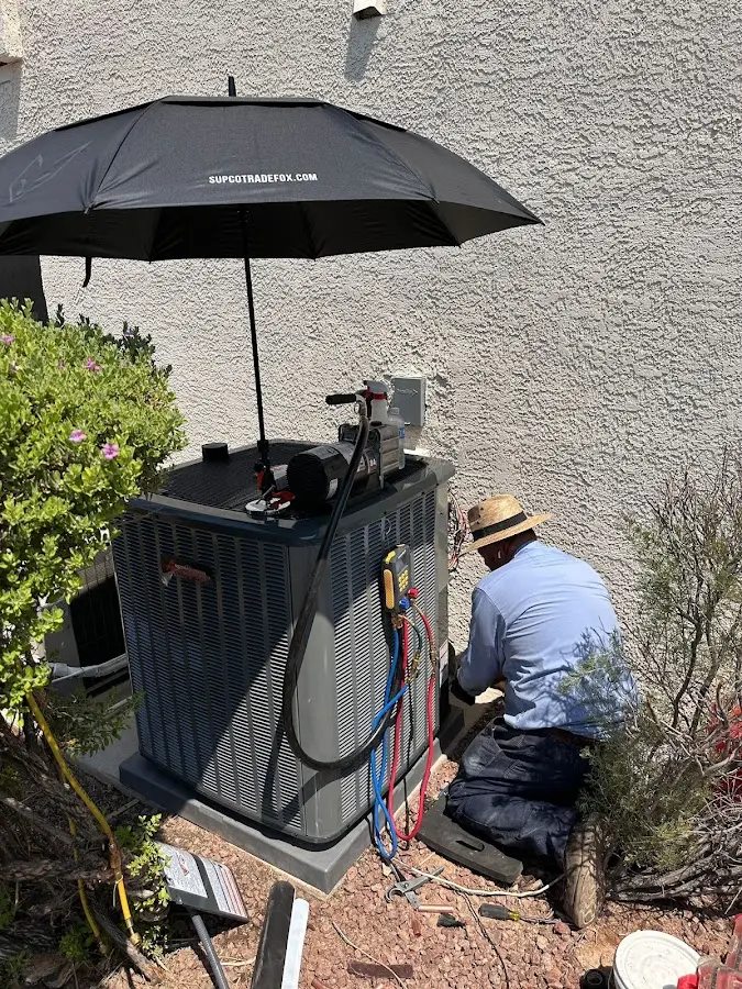 HVAC technician performing outdoor AC maintenance in Fairview Heights